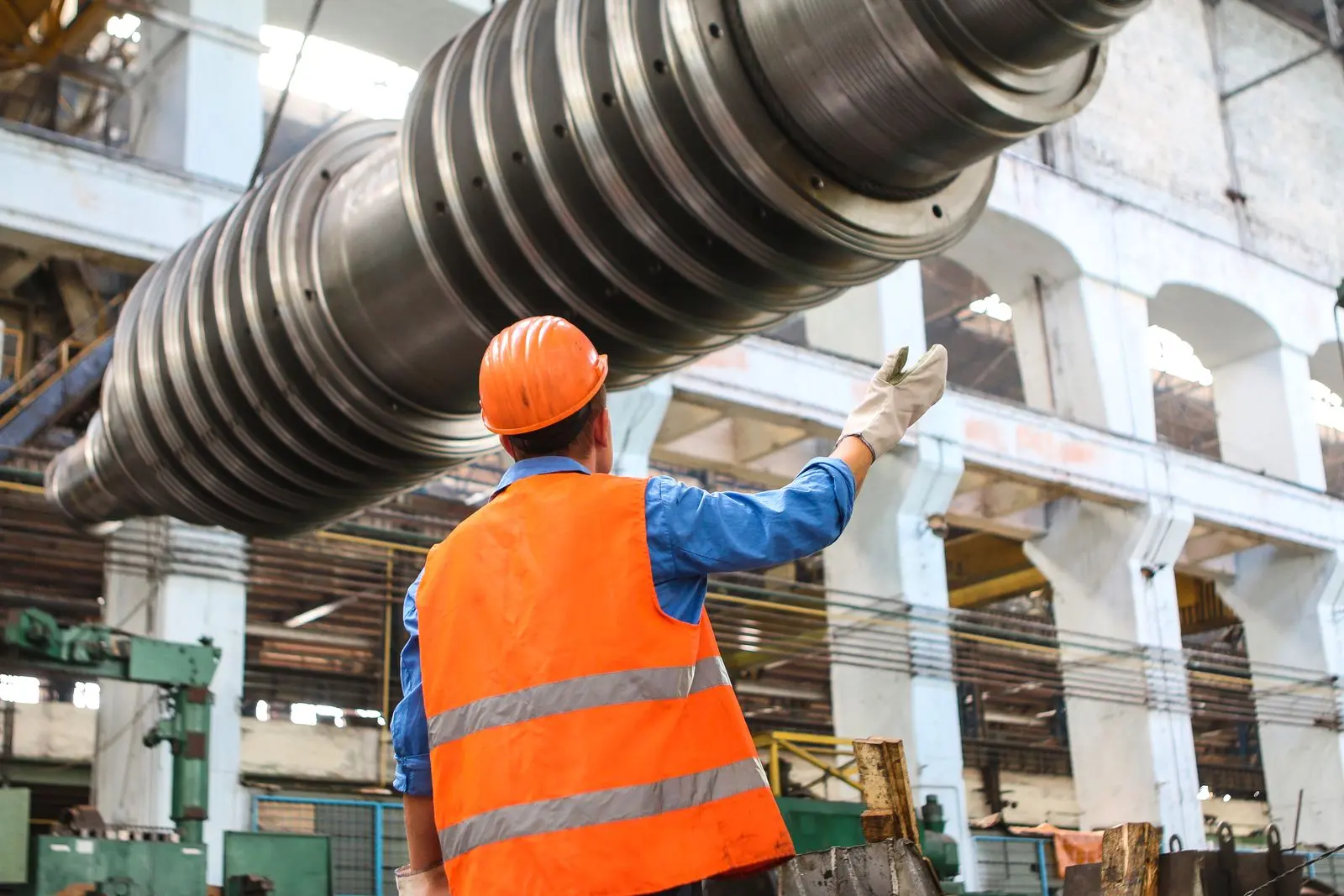 Maintenance engineer in a safety vest inspecting building equipment