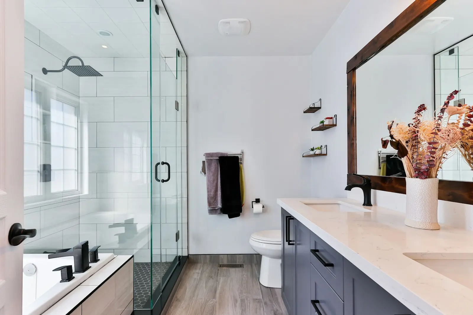 Renovated modern bathroom with glass shower enclosure and new fittings