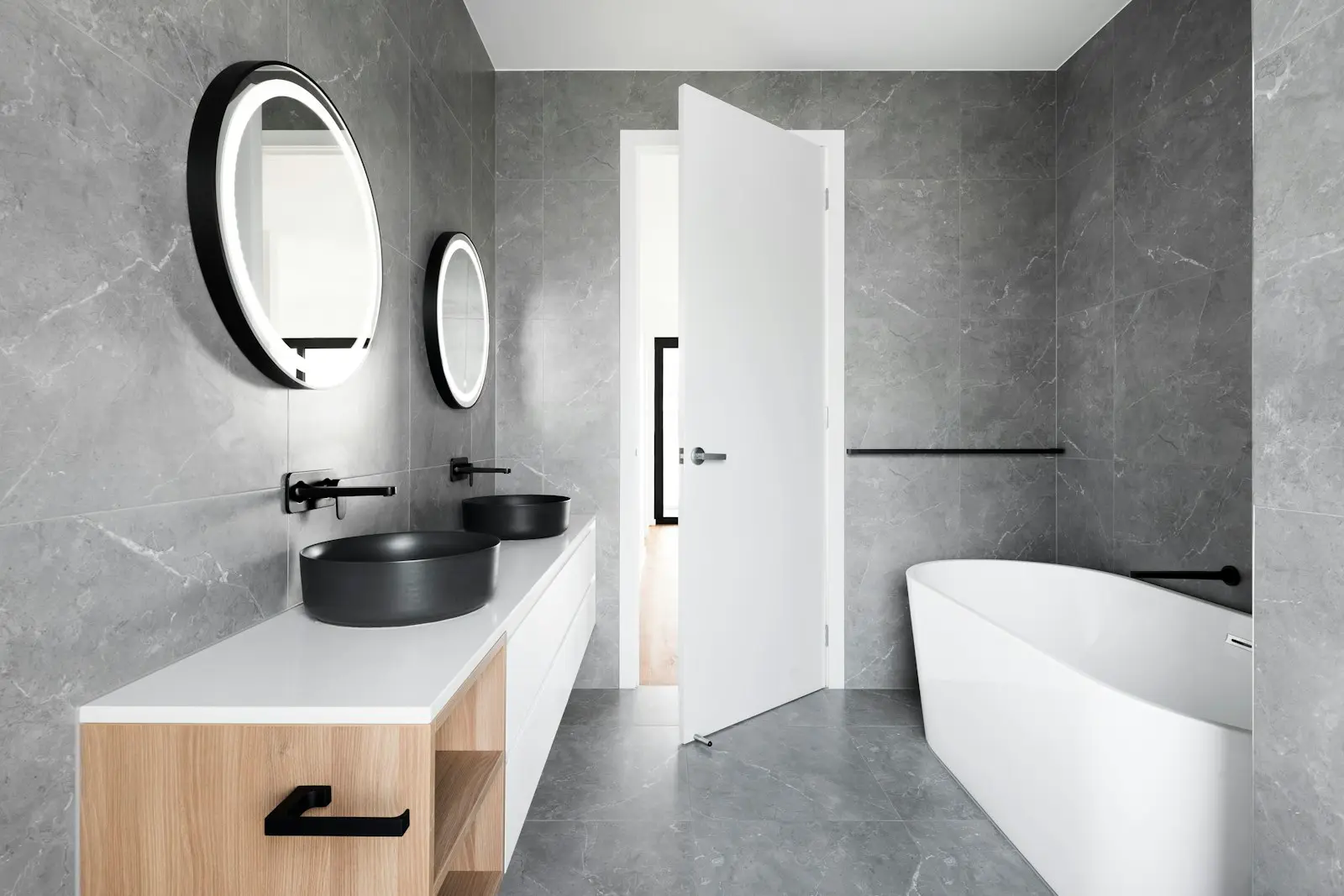 Newly renovated bathroom with marble tiles and a freestanding bathtub