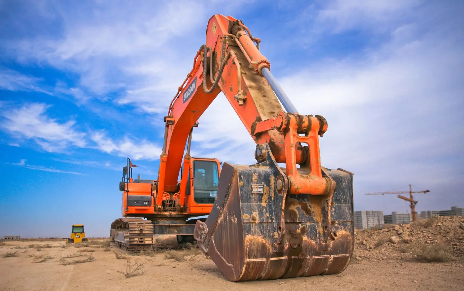 Excavator working on an infrastructure project site