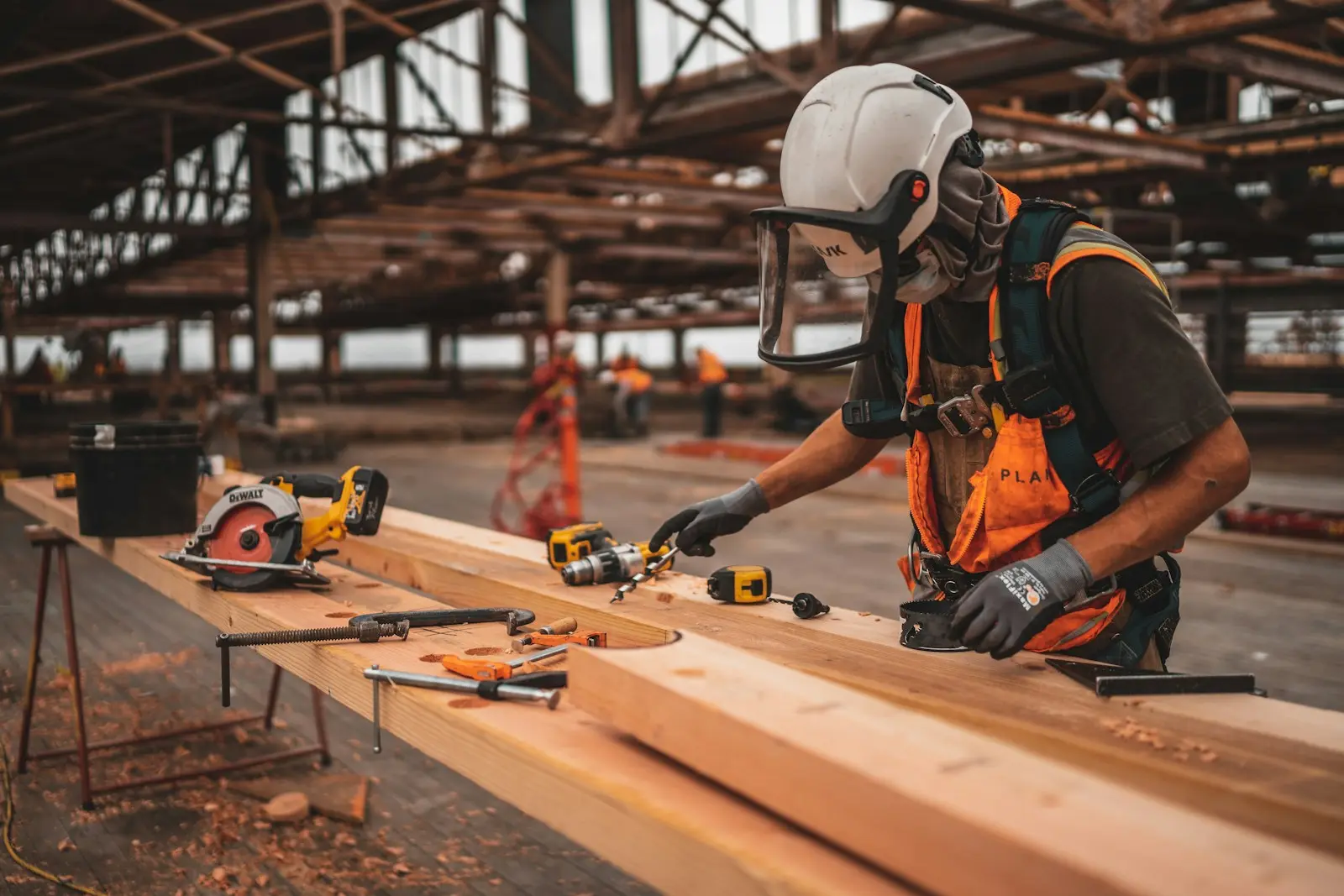 Worker carrying out structural repair work inside a large institutional building