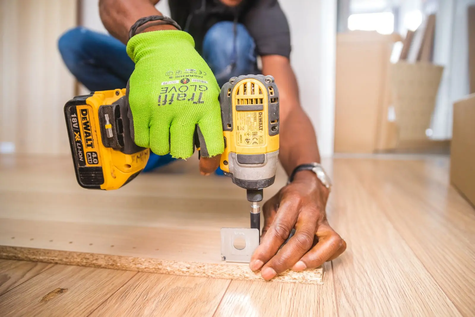 Close-up of hands using a cordless drill during repair work